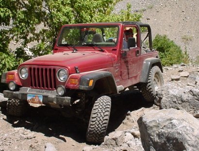 Red Jeep Warnlger in the Rocks